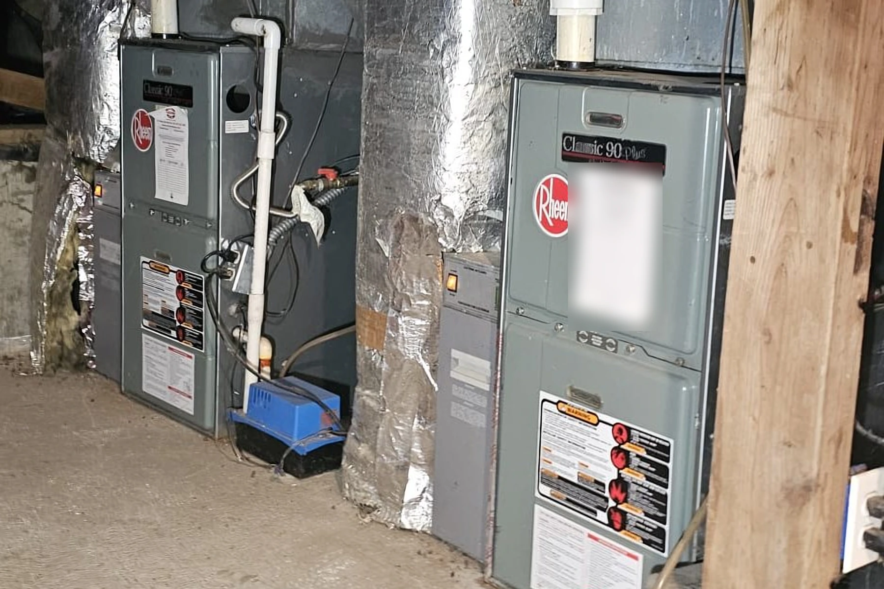 Two Rheem furnaces in a crawl space during furnace and AC maintenance in Bellevue, WA.