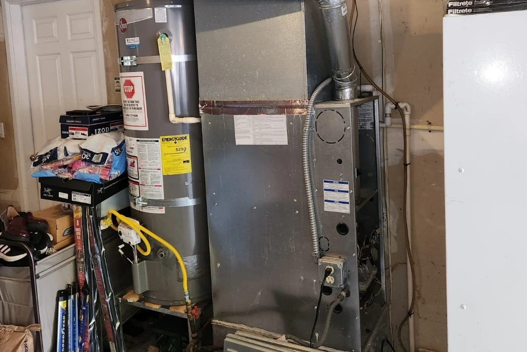 Gas furnace and water heater in a garage during furnace maintenance in Woodinville, WA.