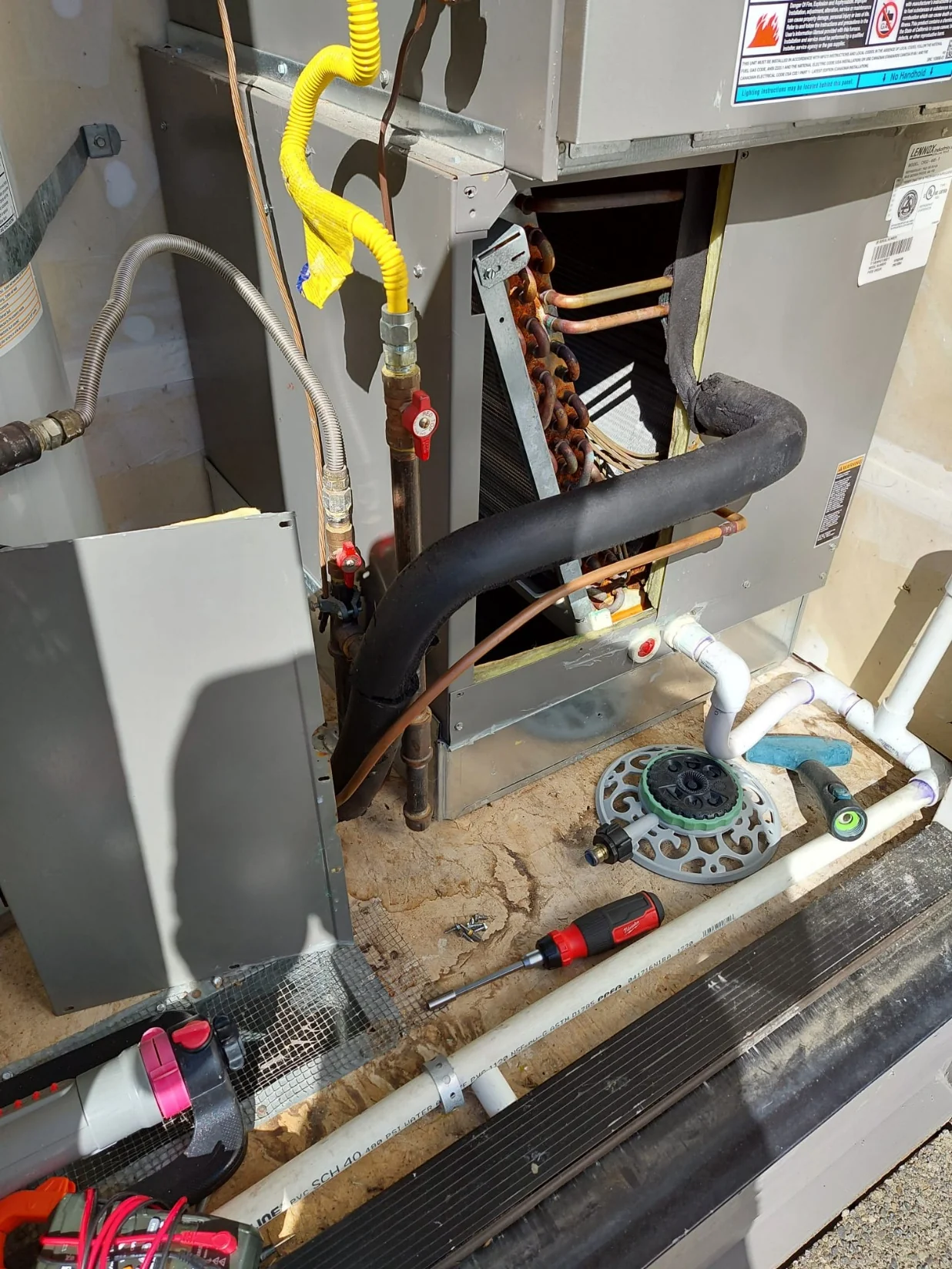 Open evaporator coil cabinet and refrigerant lines before the Snoqualmie HVAC replacement.