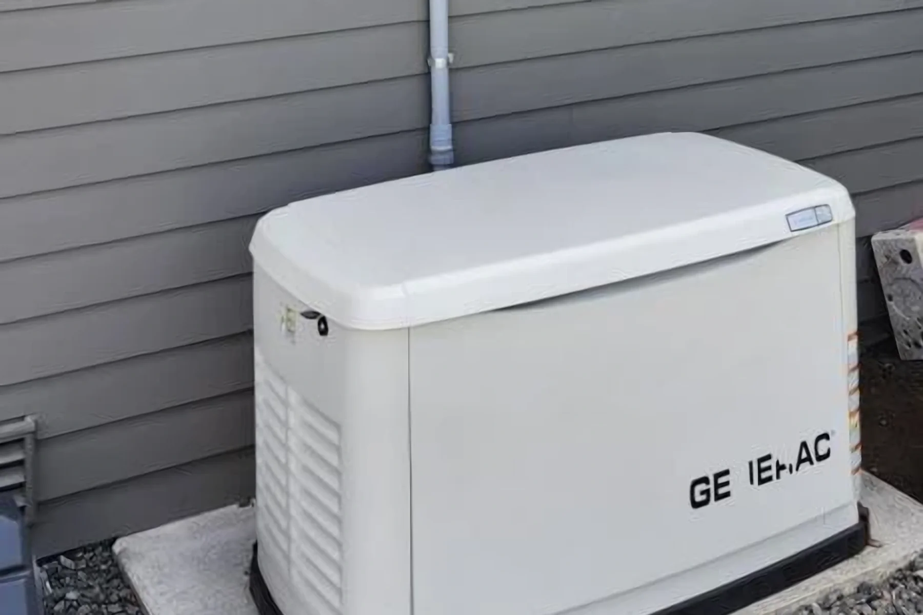 Generac standby generator on a concrete pad beside a home in Arlington, WA, ready for outage season.