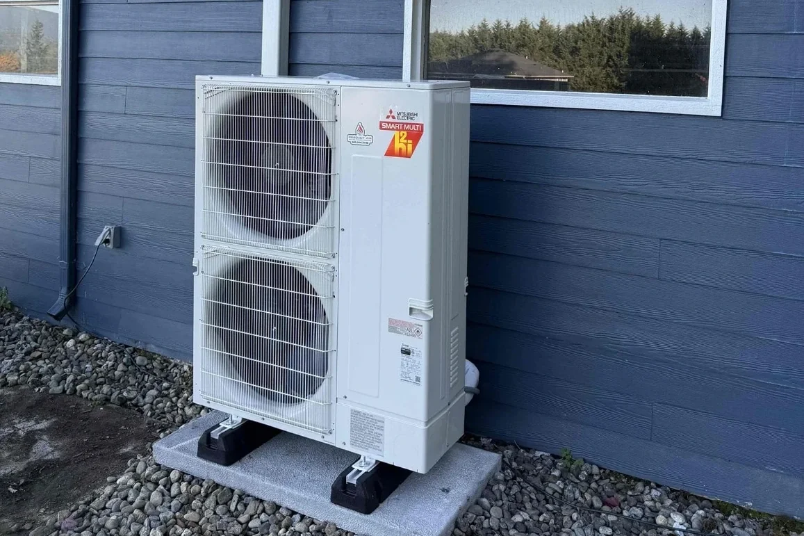 Mitsubishi Hyper Heat multi-zone outdoor heat pump on a pad at a home in Arlington, WA.