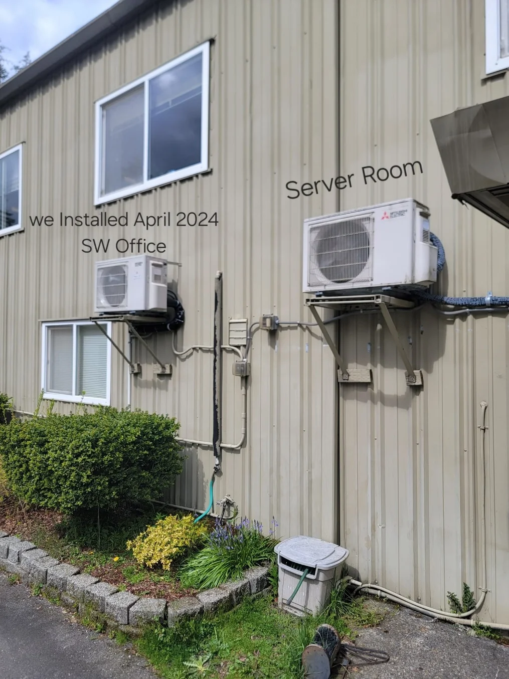 Wall-bracket-mounted Mitsubishi outdoor condensers serving the Woodinville office building